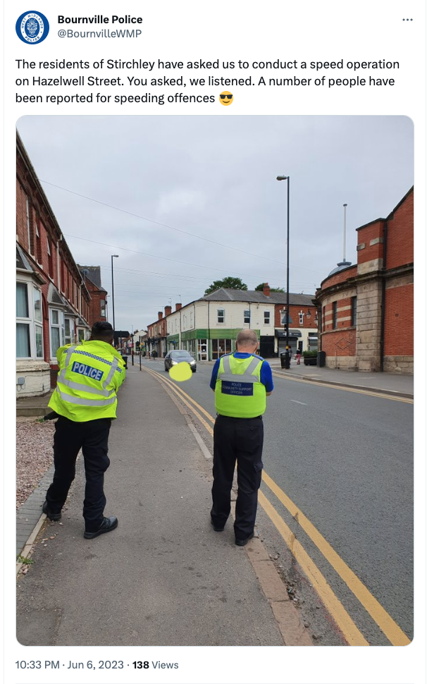 screenshot of a tweet with a photo showing two people in high-vis jackets looking towards a car